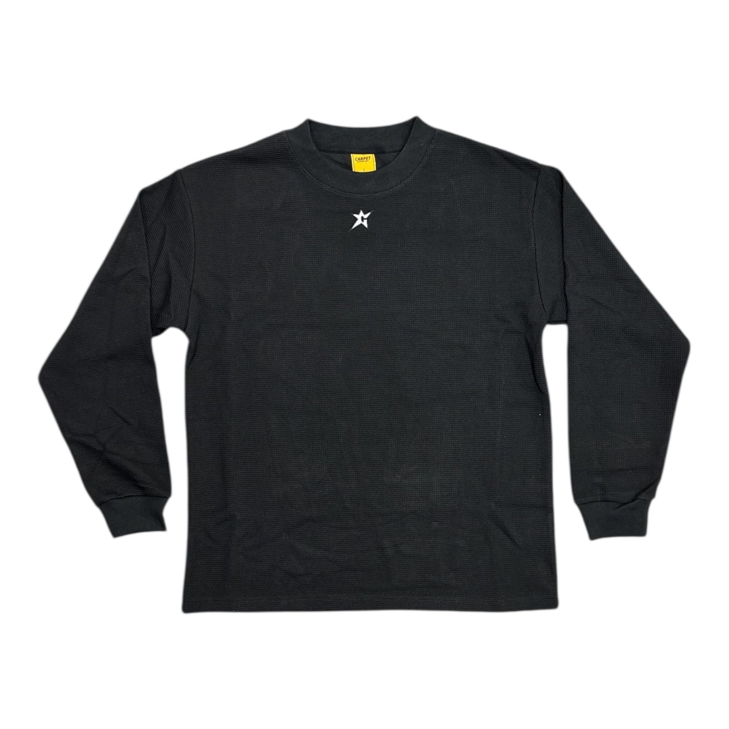 Black long-sleeve shirt with a small white logo on a white background