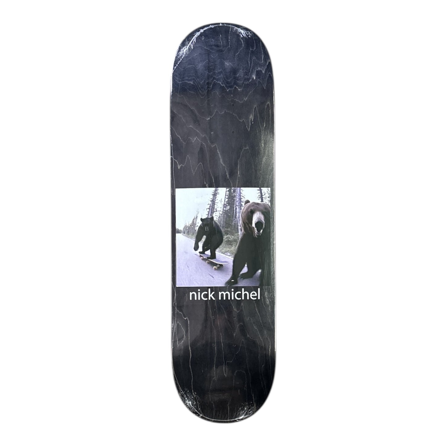 Skateboard deck with bear design and 'nick michel' branding on a white background