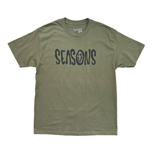 Seasons in Black Text on an Army Green Tee