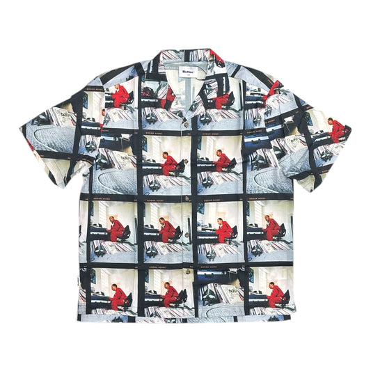 Short-sleeve shirt with a pattern of a person in a red outfit on a white background