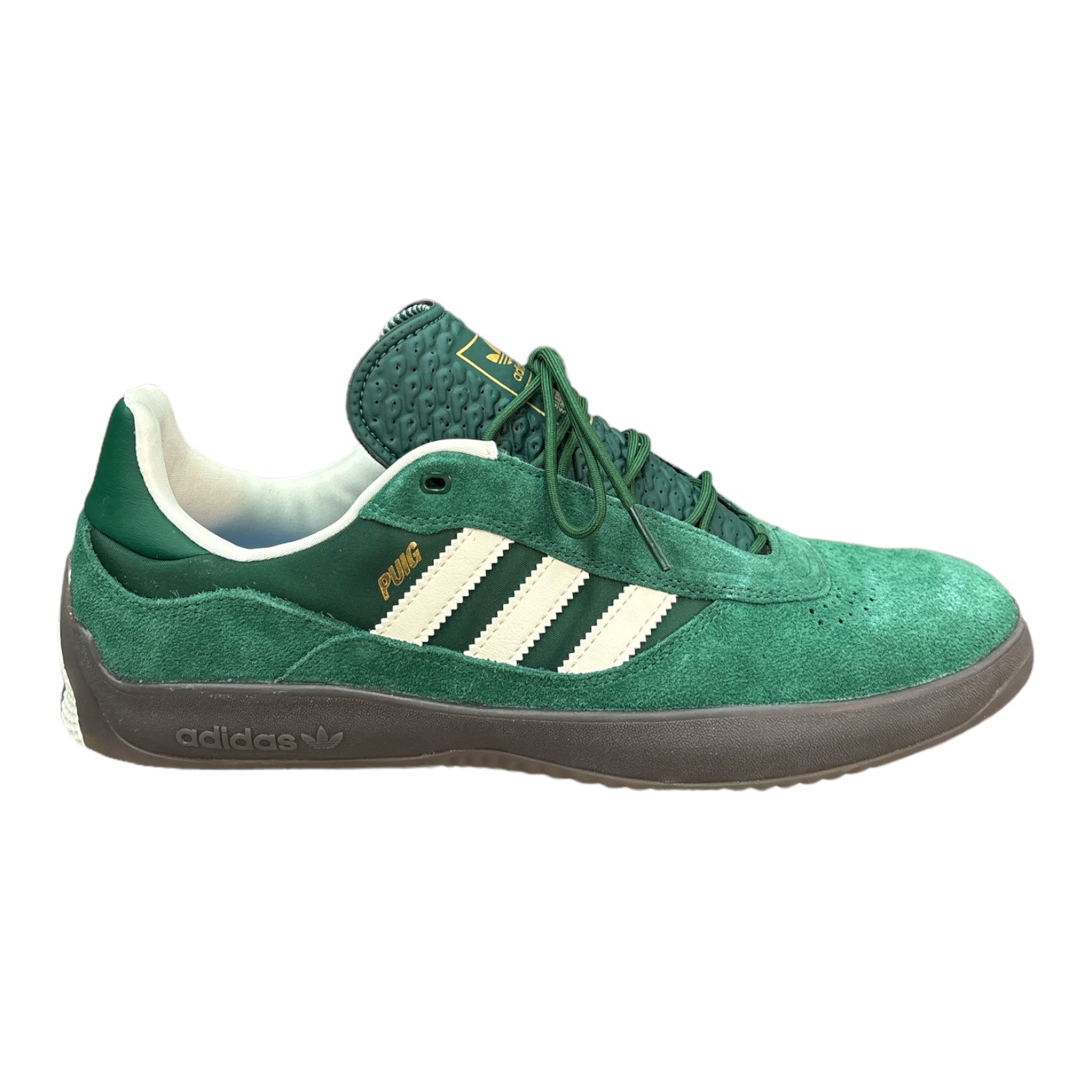 Adidas Puig in Forest Green Suede with Gum Outsole & Cream Colored Stripes. 