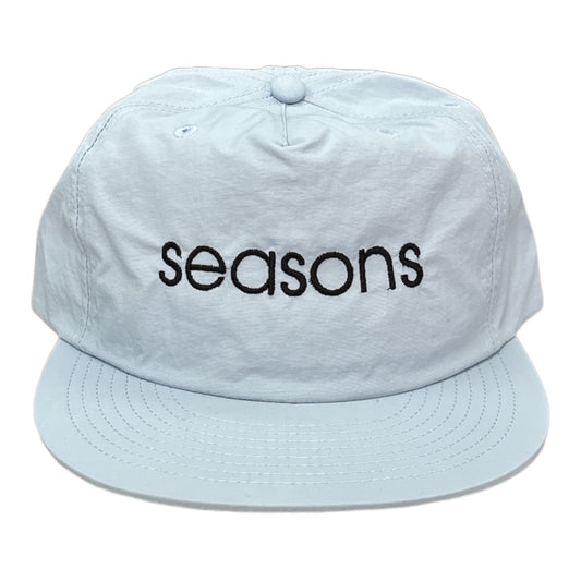 Powder, blue nylon hat, embroidery on front black thread spells, Seasons