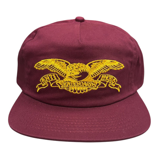 Maroon cap with yellow eagle emblem on a white background