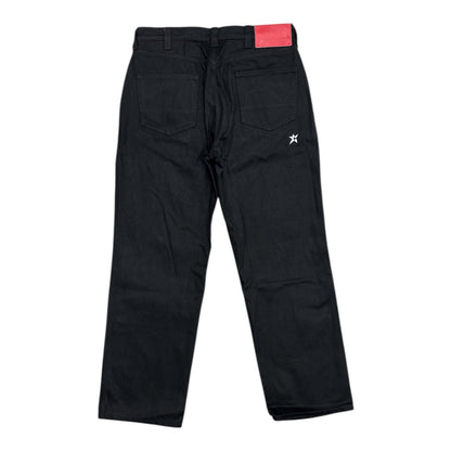 Black pants with a red tag on a white background