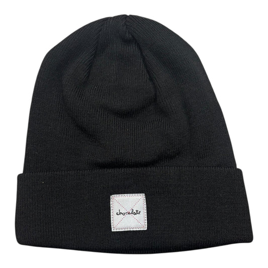 Black beanie with a white label on a white background