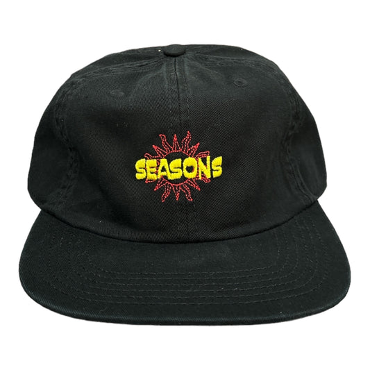 Black cotton hat with embroidered sun and the word seasons in red and yellow