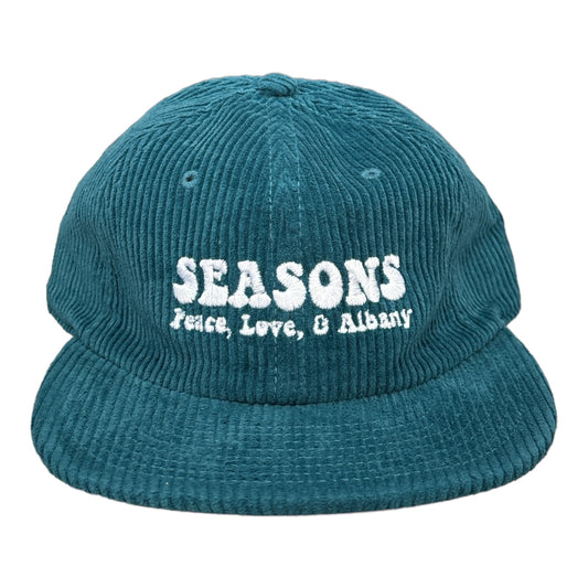 Blue corduroy hat says seasons in white letters