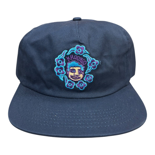 Navy blue cap with embroidered design on a white background