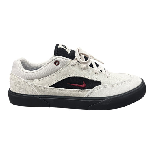 White sneaker with black sole and red swoosh logo on a white background