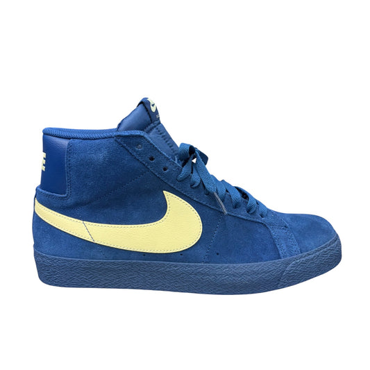 A blue suede high-top sneaker with a prominent light yellow Nike Swoosh on the side, set against a plain white background.