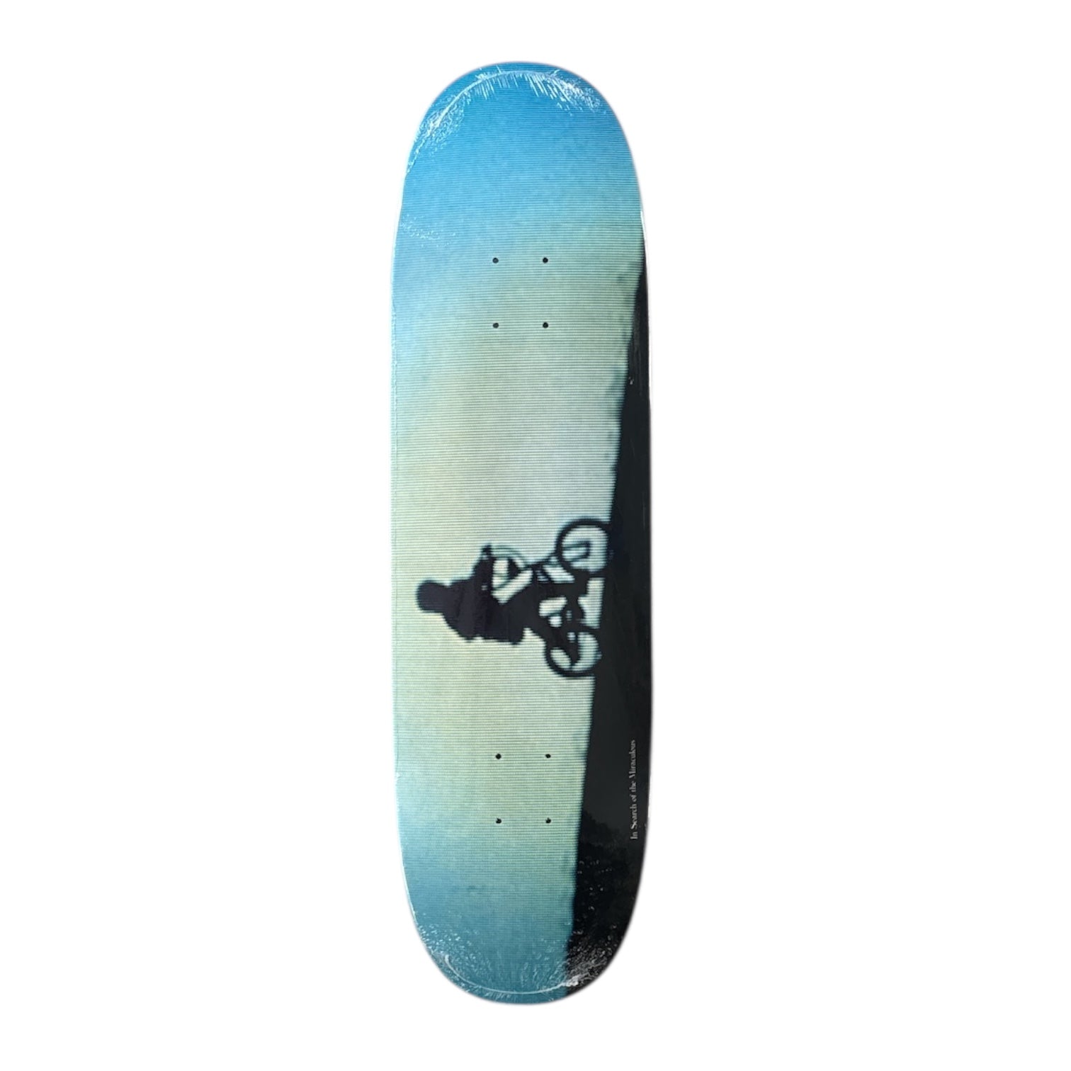 Skateboard deck with a gradient blue and green design and a silhouette of a biker, on a white background.