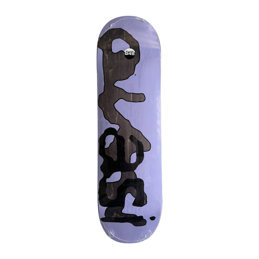 A skateboard deck with a light purple background and a large black abstract graphic printed vertically down the center. The deck is shown in its clear plastic shrink-wrap packaging against a solid white background.