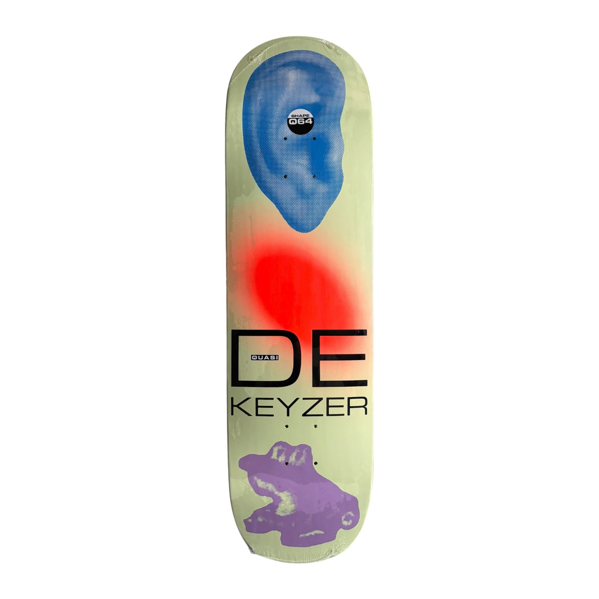 A skateboard deck featuring a cream-colored background with a blue ear graphic at the top, a red glow effect in the center, a purple frog illustration at the bottom, and the text 'DE KEYZER' printed in black.