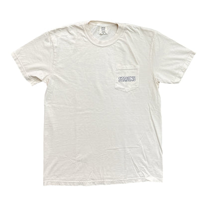 An off-white short-sleeve pocket t-shirt with a small blue and white graphic on the chest pocket reading 'SEMPER FLEURIS'.