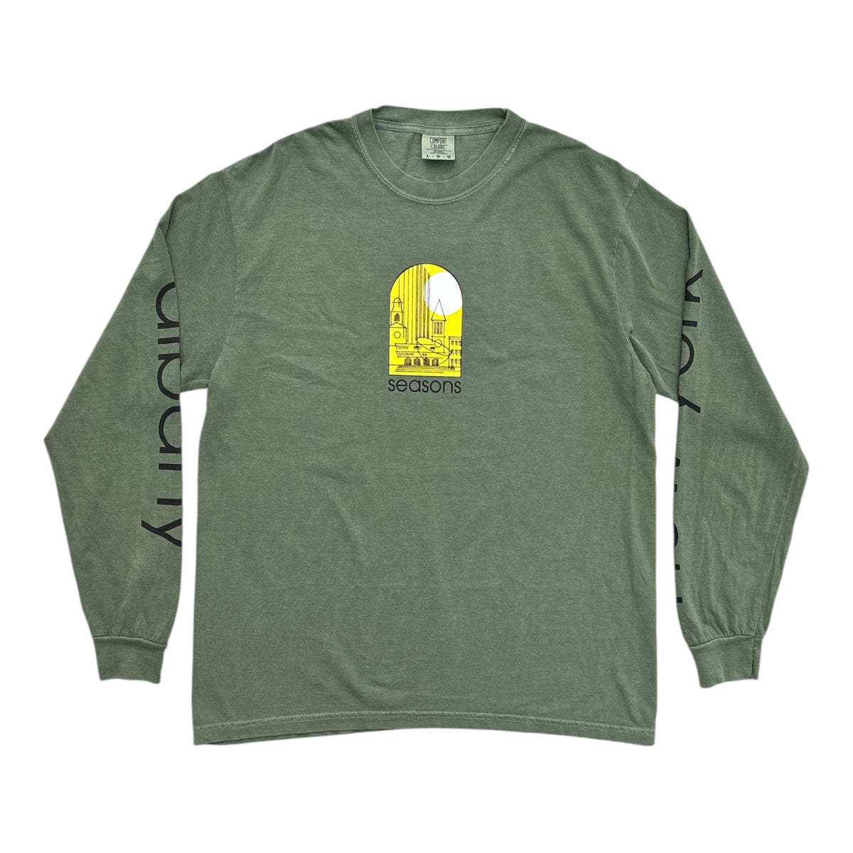 An olive green long-sleeve t-shirt with a yellow and white graphic on the chest and black text printed vertically down both sleeves, displayed flat against a white background.