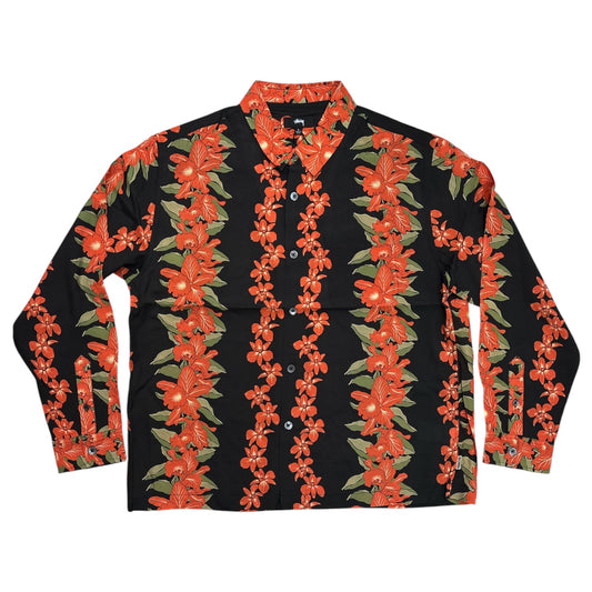 A long-sleeve button-up shirt with a black base and a vibrant red-orange floral pattern with green leaves, laid flat on a white background.
