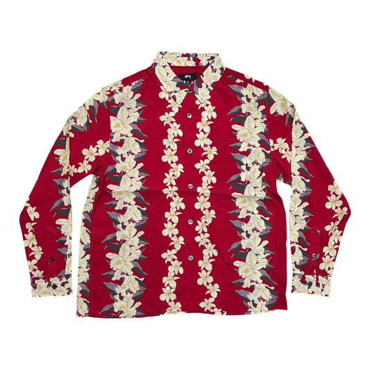 A long-sleeve button-up shirt in red with vertical floral patterns of cream and yellow flowers with green leaves, laid flat on a white background.