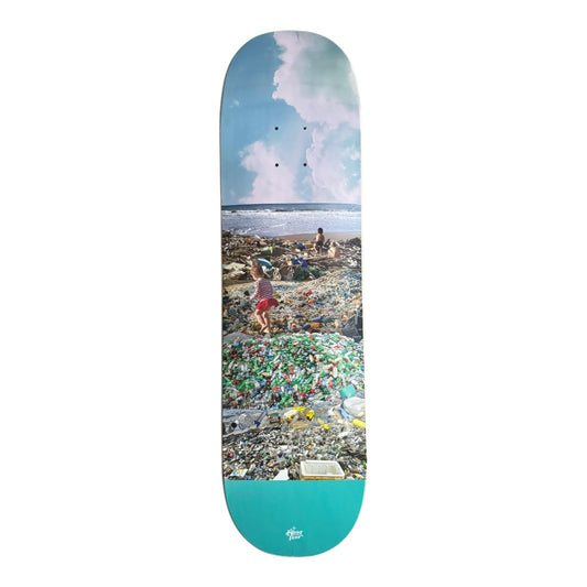 Skateboard deck with a beach and pollution graphic on a white background