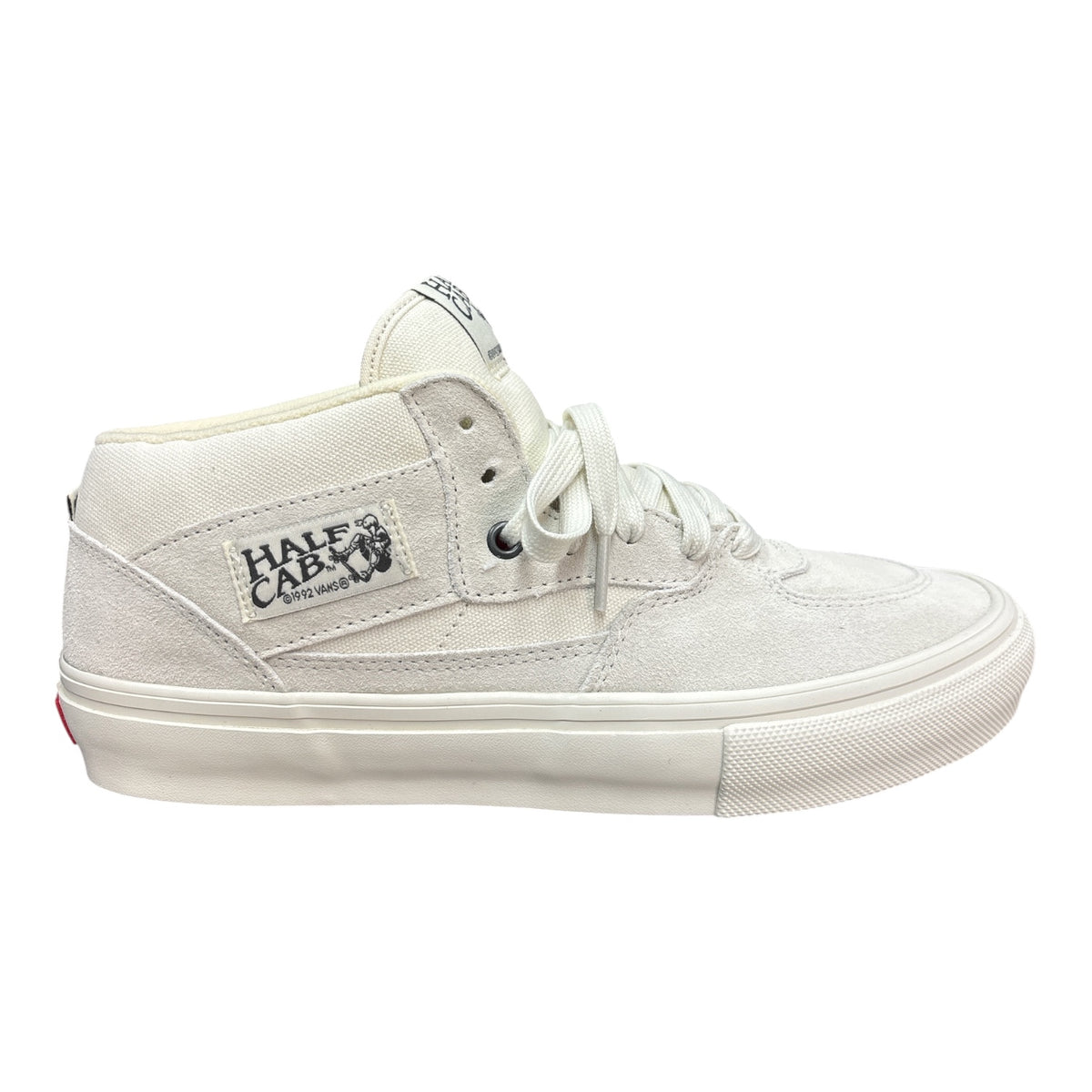 A white mid-top skate shoe from Half Cab, featuring a canvas upper, white laces, and a thick white rubber sole, shown from a side profile on a white background.