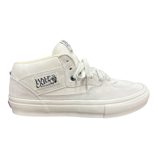 A white mid-top skate shoe from Half Cab, featuring a canvas upper, white laces, and a thick white rubber sole, shown from a side profile on a white background.