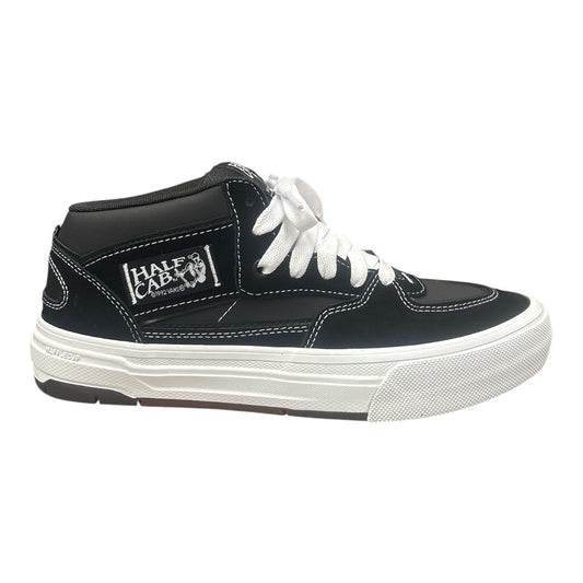 Black high-top sneaker with white laces on a white background