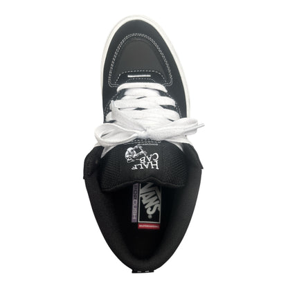 Black sneaker with white laces on a white background
