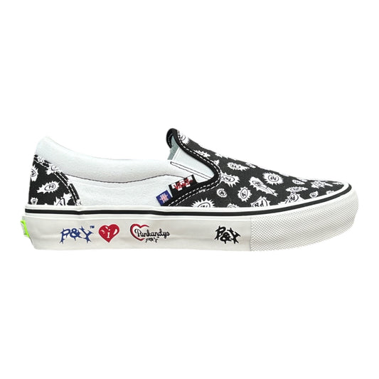 A slip-on platform sneaker featuring a black and white floral pattern on the canvas upper, a white rubber platform sole, and colorful graphic prints on the side including a red heart and blue graffiti-style text.