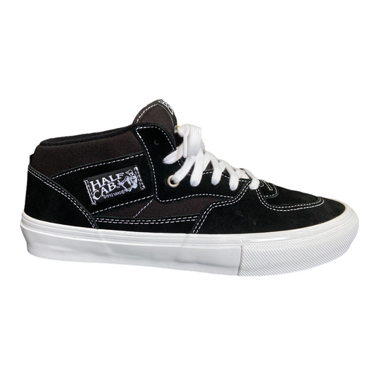 Vans Skate Half Cab sneaker in black and white with lace-up closure, displaying the iconic Vans checkerboard pattern on the side.